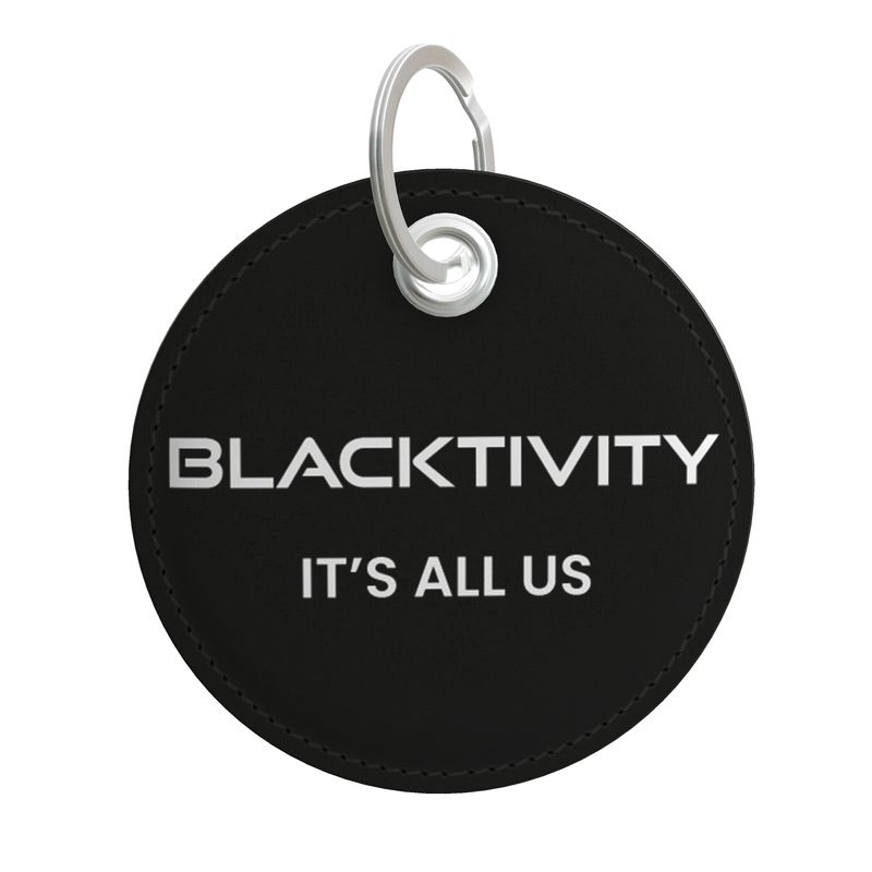 Black round keychain with 'BLACKTIVITY IT'S ALL US' text on a white background